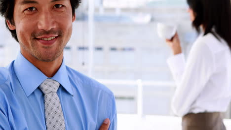 Businessman-smiling-at-camera-wearing-a-smart-watch