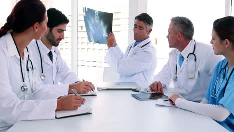 Medical-team-looking-at-x-ray-during-a-meeting