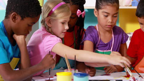 Preschool-class-painting-at-table-in-classroom