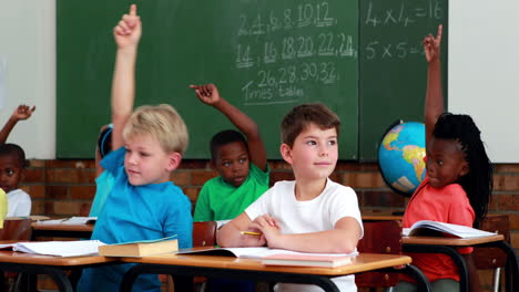 Pupils-listening-and-raising-their-hands-during-class