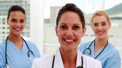 Medical-team-smiling-at-camera-together