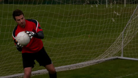 Goalkeeper-in-red-saving-a-goal-during-a-game