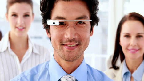 Businessman-smiling-at-camera-wearing-smart-glasses