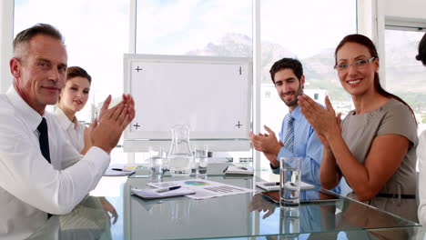 Business-team-applauding-the-camera-at-meeting