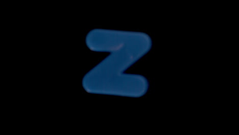 The-letter-z-coming-into-focus-on-black-background