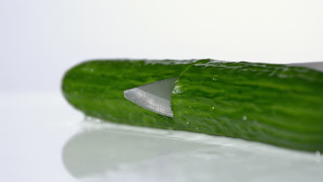 Courgette-being-sliced-on-white-background