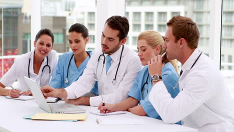 Medical-team-looking-at-laptop-during-meeting