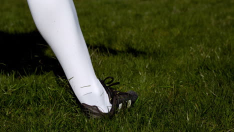 Football-player-kicking-the-ball-on-grass