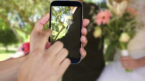 Hand-showing-wedding-clips-on-smartphone