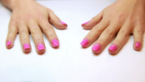 Hands-showing-fresh-pink-manicure