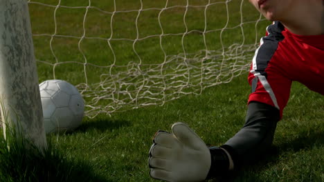 Goalkeeper-in-red-letting-in-a-goal-during-a-game