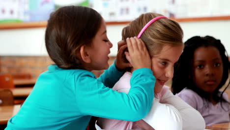Little-girls-telling-secrets-in-the-classroom