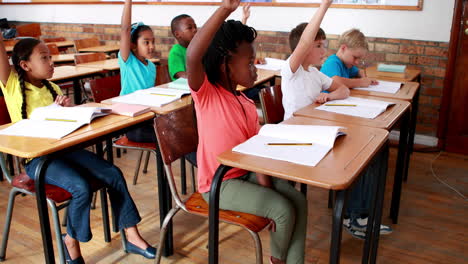 Pupils-raising-their-hands-during-class