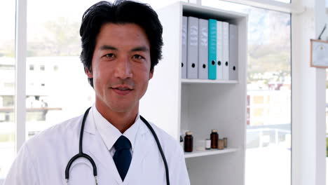 Handsome-young-doctor-smiling-at-camera