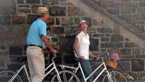 Senior-couple-going-on-a-bike-ride-in-the-city-