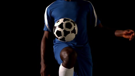 Football-player-in-blue-controlling-the-ball