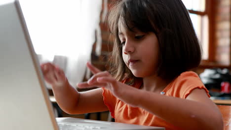 Little-girl-using-laptop-in-classroom