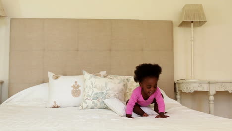 Cute-baby-girl-standing-and-clapping-on-bed