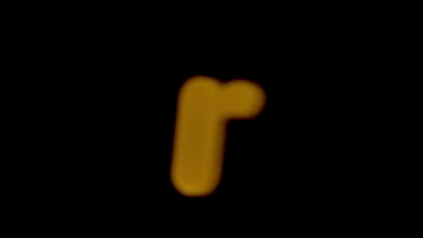 The-letter-r-coming-into-focus-on-black-background