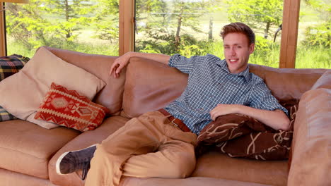 Handsome-young-man-relaxing-on-his-couch