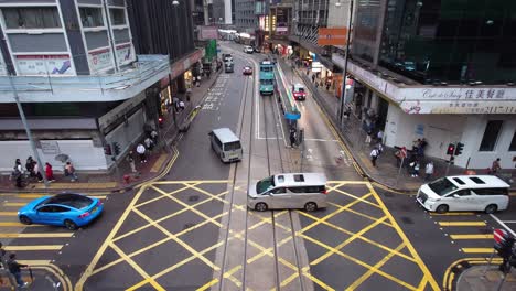 Traffic-view-of-Central-Des-Voeux-Road-under-a-cloudy-day-in-Hong-Kong,-China