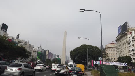 Cars-Driving-POV-Revealing-Obelisk-of-Buenos-Aires-City-in-autumn-Skyline
