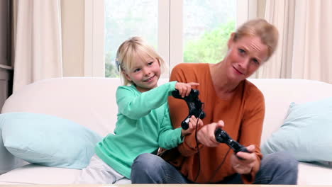 Cute-little-girl-playing-video-games-with-her-mother