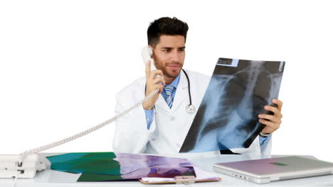 Young-doctor-working-at-his-desk