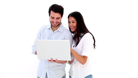 Attractive-young-couple-using-laptop