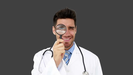 Young-doctor-looking-through-magnifying-glass
