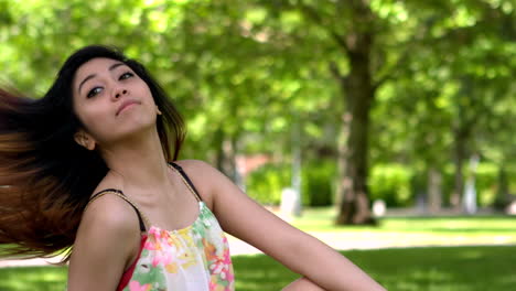 Pretty-asian-girl-tossing-her-hair-in-the-park