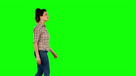 Casual-brunette-walking-on-green-screen