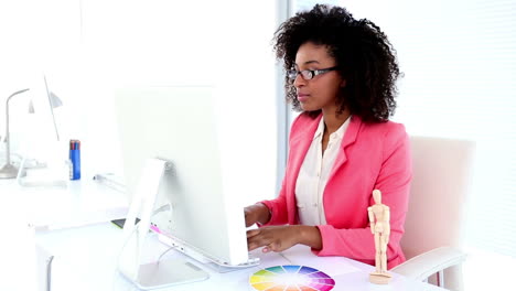 Pretty-designer-working-at-her-desk