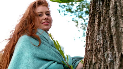 Pretty-redhead-wrapped-in-blanket-by-a-tree