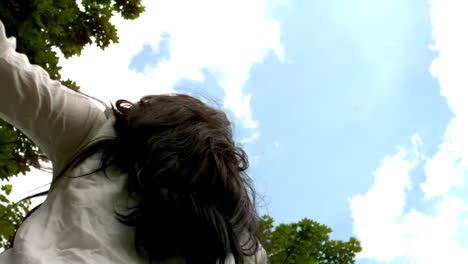 Carefree-brunette-spinning-in-the-park