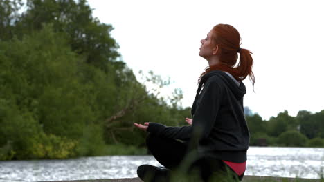 Pelirroja-Tranquila-Haciendo-Yoga-Junto-A-Un-Lago-