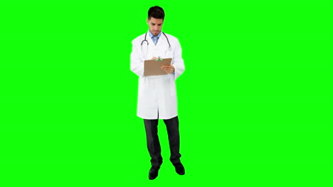 Young-doctor-standing-with-clipboard