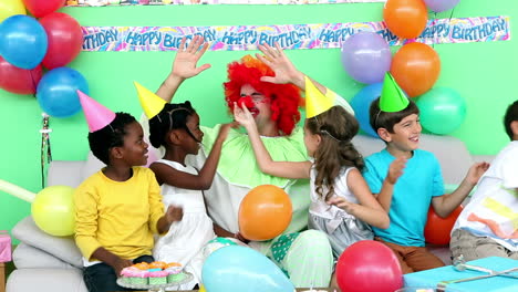 Cute-children-celebrating-a-birthday-with-a-clown