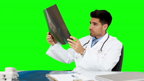 Young-doctor-working-at-his-desk