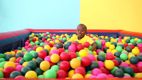 Cute-little-boy-emerging-from-ball-pool