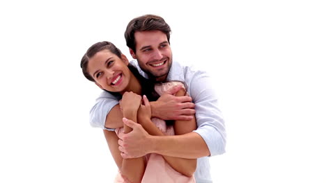 Attractive-young-couple-hugging-and-smiling-at-camera