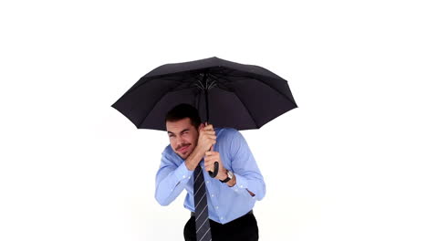 Young-businessman-sheltering-with-umbrella