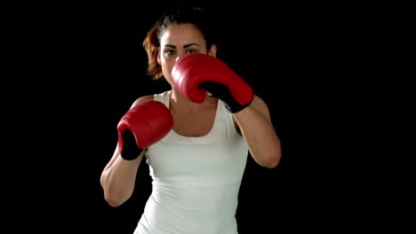 Brunette-punching-in-boxing-gloves