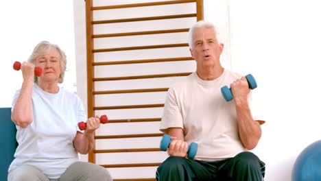 Active-seniors-lifting-hand-weights