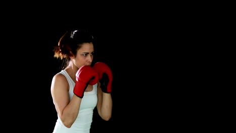 Fit-brunette-punching-with-gloved-fists