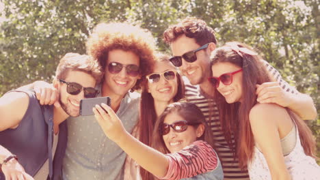 In-slow-motion-happy-friends-in-the-park-taking-selfie