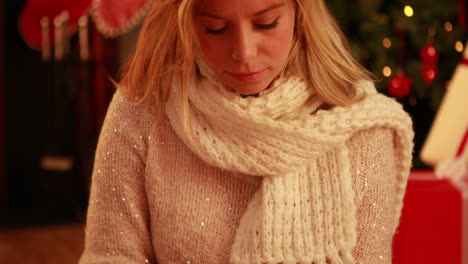Pretty-blonde-using-tablet-at-christmas