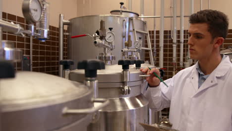 Brewery-worker-checking-the-vats