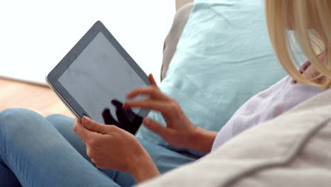 Woman-using-tablet-on-couch