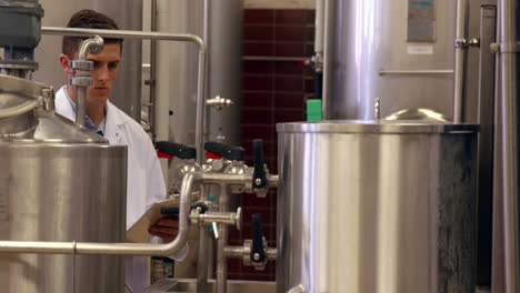 Brewery-worker-checking-the-vats